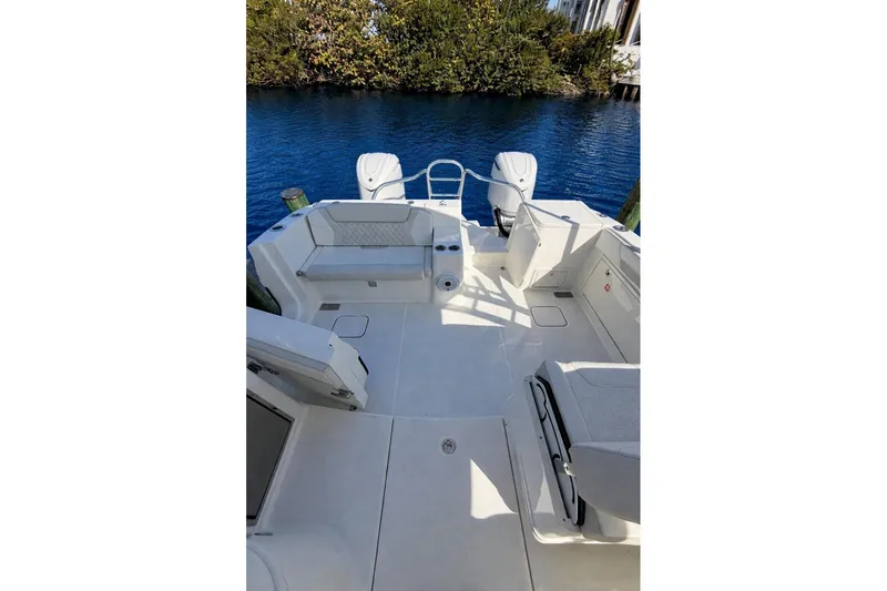 Slide: The Image of 2026 World Cat 325 DC boat deck with seating, overlooking calm blue water. - 13
