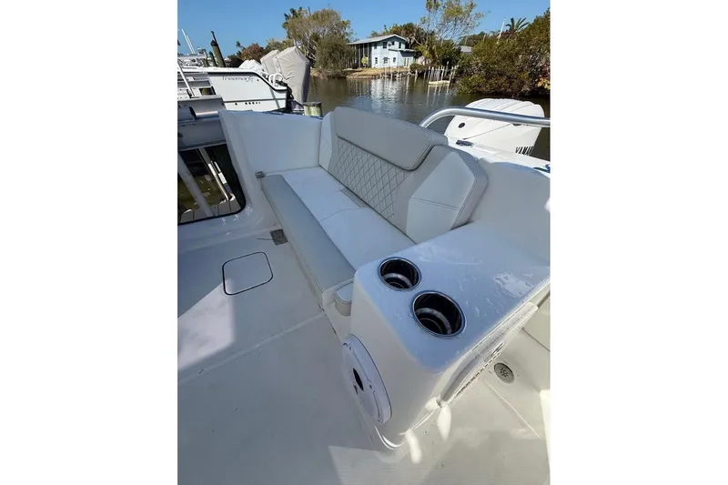 Slide: The Image of 2026 World Cat 325 DC boat interior with white seating and cup holders. - 14