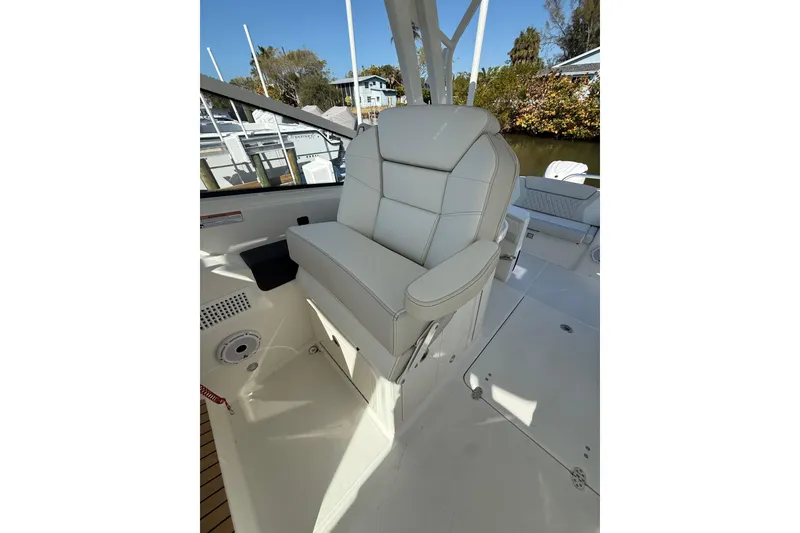 Slide: The Image of Luxury seating on 2026 World Cat 325 DC boat, featuring premium white upholstery. - 15