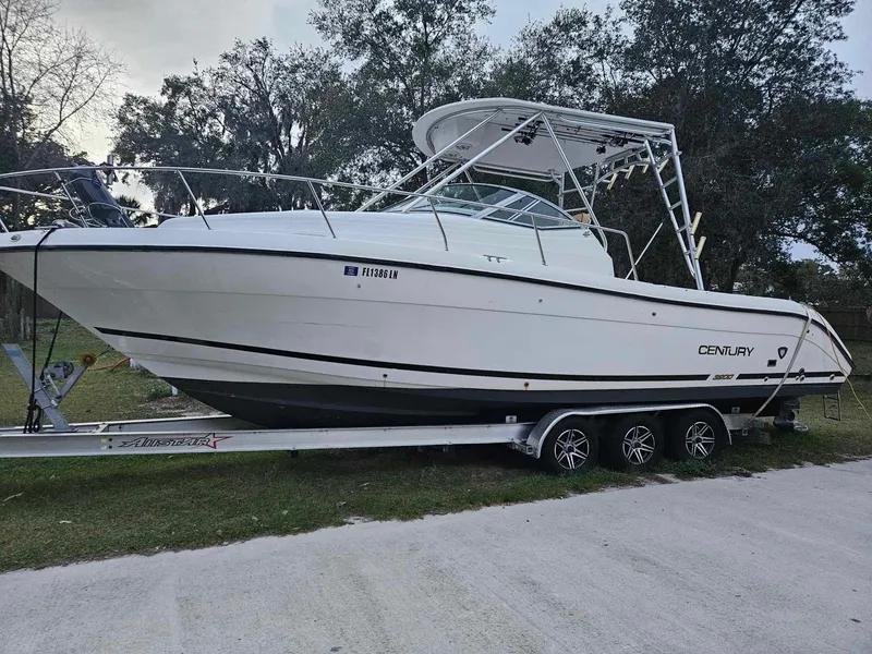 Slide: The Image of 2001 Century 3200 Walk-Around boat on a trailer, side view. - 0