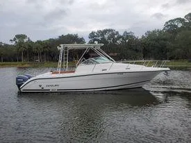 Slide: The Image of 2001 Century 3200 Walk-Around boat on a calm lake. - 12