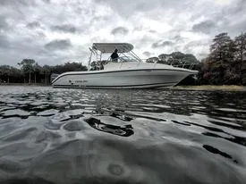 Slide: The Image of 2001 Century 3200 Walk-Around boat on calm water with cloudy sky. - 16