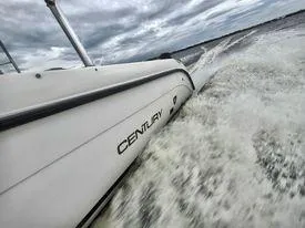 Slide: The Image of Century 3200 Walk-Around 2001 boat cruising on water with cloudy sky background. - 17