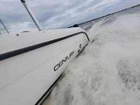 Slide: The Image of 2001 Century 3200 Walk-Around boat speeding on water. - 18