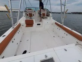 Slide: The Image of 2001 Century 3200 Walk-Around boat with spacious deck and seating on the water. - 23