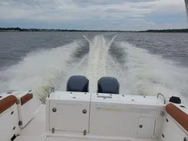 Slide: The Image of 2001 Century 3200 Walk-Around boat cruising on open water. - 25