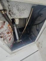 Slide: The Image of 2001 Century 3200 Walk-Around boat interior compartment with visible plumbing and wiring. - 34