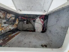 Slide: The Image of 2001 Century 3200 Walk-Around boat storage compartment with visible wiring and equipment. - 36