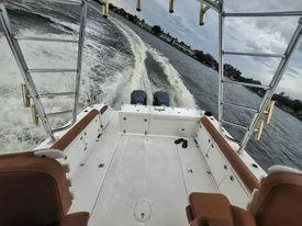 Slide: The Image of 2001 Century 3200 Walk-Around boat cruising on water, rear view. - 37