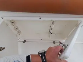 Slide: The Image of Person inspecting storage compartment on 2001 Century 3200 Walk-Around boat. - 43