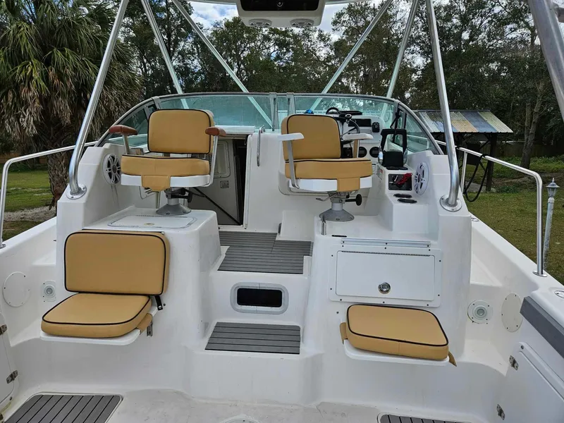 Slide: The Image of 2001 Century 3200 Walk-Around boat interior with tan seats and white deck. - 5