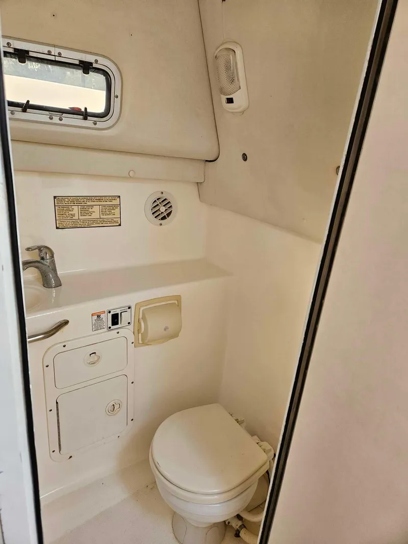 Slide: The Image of 2001 Century 3200 Walk-Around boat bathroom with sink and toilet. - 6
