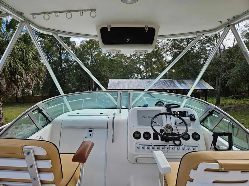 Slide: The Image of 2001 Century 3200 Walk-Around boat cockpit with steering wheel and control panel. - 7
