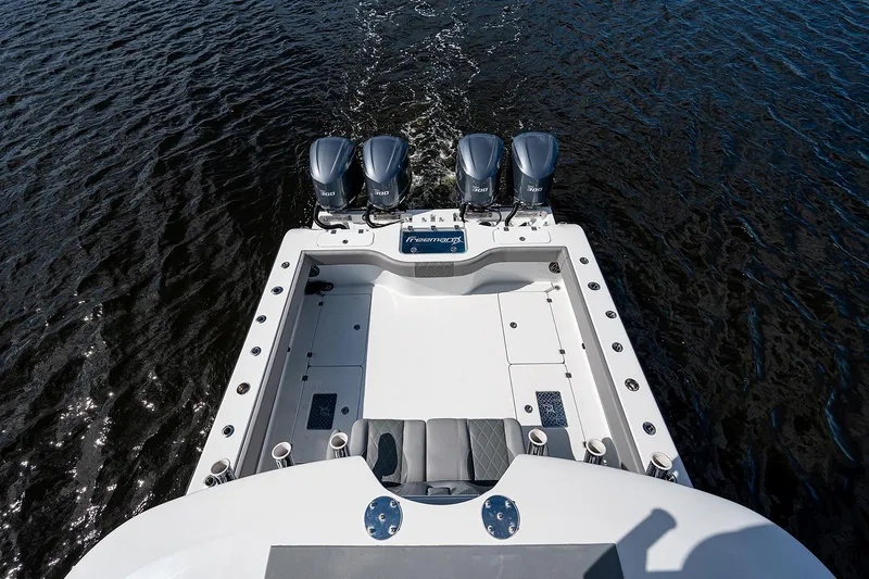Slide: The Image of 2019 Freeman 37 boat with four outboard motors on water. - 1