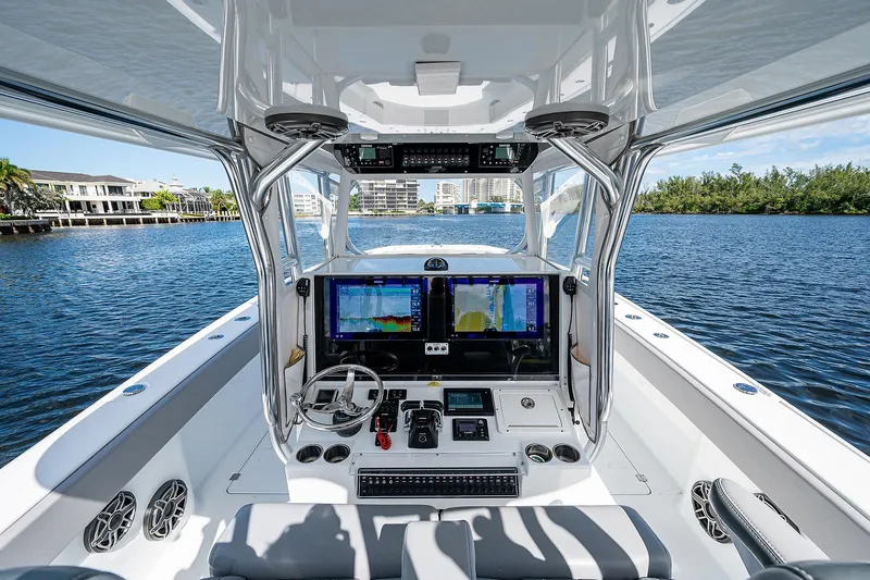 Slide: The Image of 2019 Freeman 37 boat cockpit with dual navigation screens on a sunny day. - 13