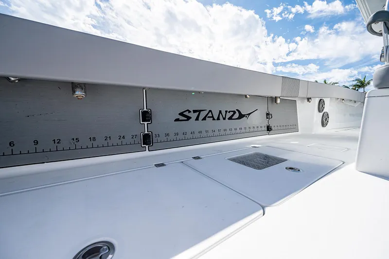 Slide: The Image of Freeman 37 boat deck with fish measuring ruler, 2019 model, under a bright sky. - 18