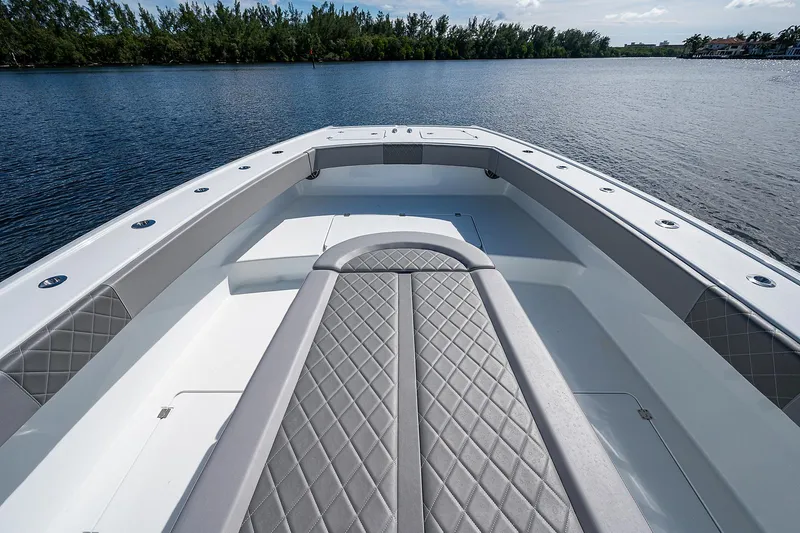 Slide: The Image of 2019 Freeman 37 boat bow with cushioned seating on calm water. - 32