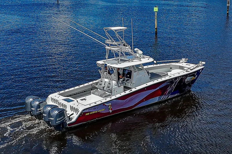 Slide: The Image of 2019 Freeman 37 boat with vibrant design on calm water. - 36