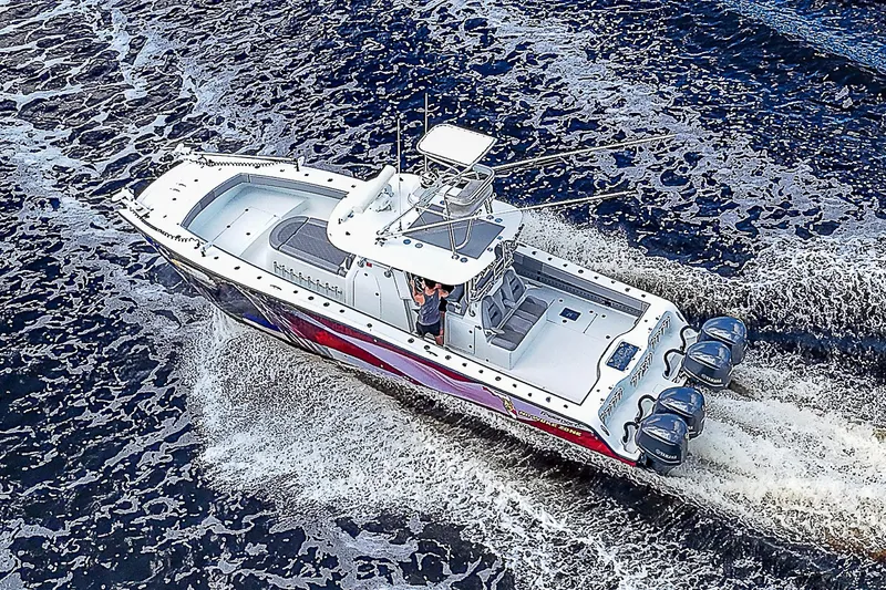 Slide: The Image of Aerial view of 2019 Freeman 37 boat cruising on water with three outboard motors. - 37