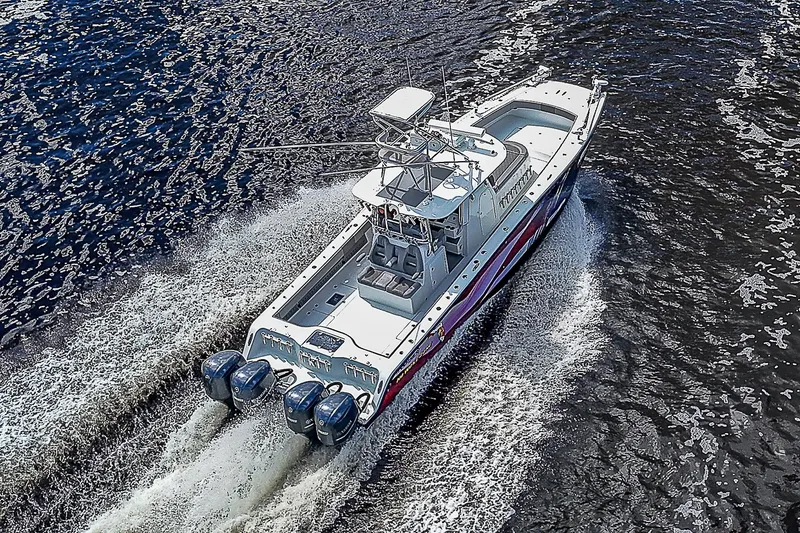 Slide: The Image of Aerial view of 2019 Freeman 37 boat cruising on water with four engines. - 38