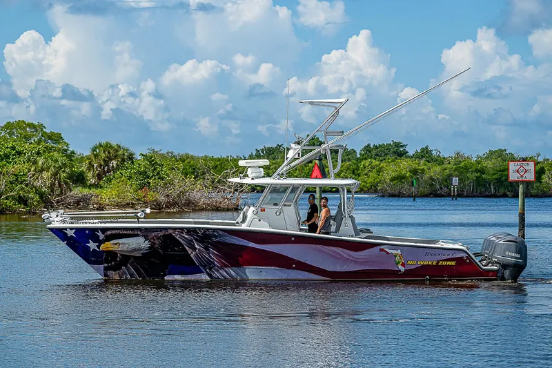 Slide: The Image of 2019 Freeman 37 boat with custom paint, cruising on a scenic waterway. - 40