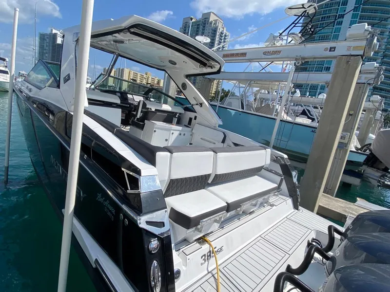 Slide: The Image of 2018 Monterey 385 SE yacht docked at marina with modern cityscape background. - 1