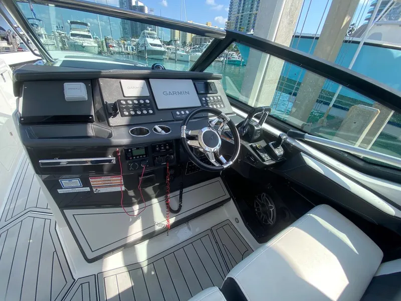 Slide: The Image of 2018 Monterey 385 SE boat cockpit with Garmin navigation, sleek design, and modern controls. - 11