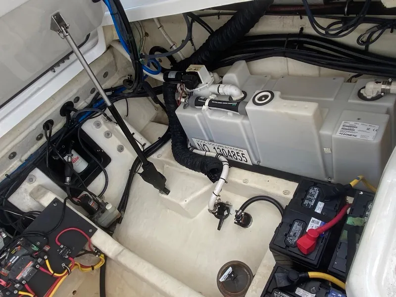 Slide: The Image of Engine compartment of a 2018 Monterey 385 SE boat, showing battery and fuel system components. - 17