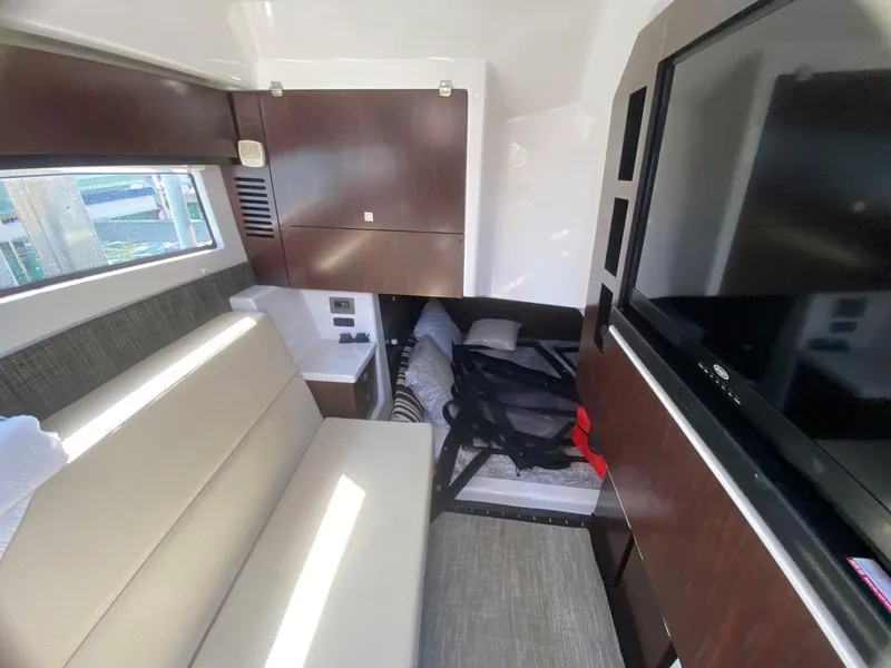 Slide: The Image of Interior of 2018 Monterey 385 SE yacht with sofa, TV, and storage cabinets. - 21