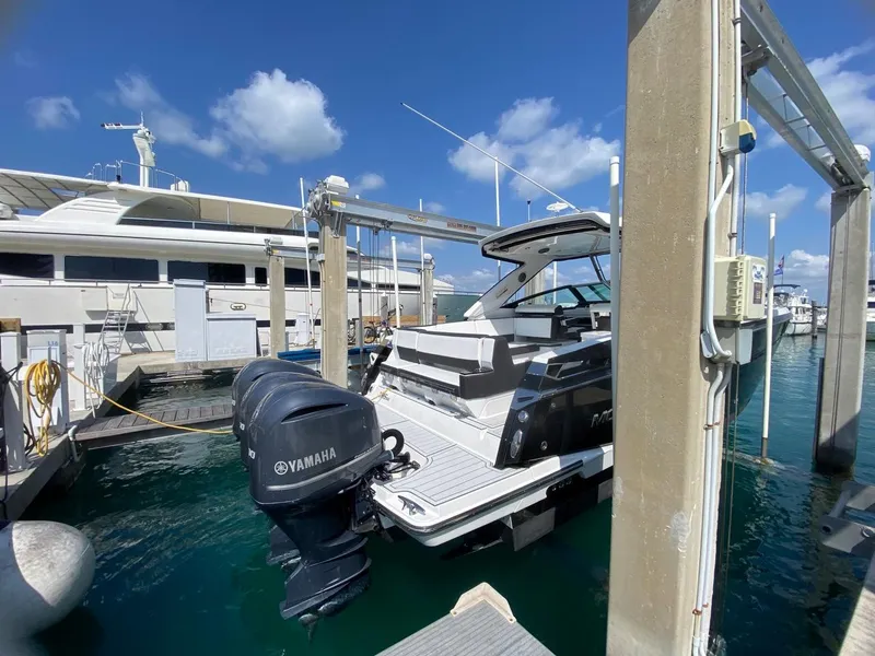Slide: The Image of 2018 Monterey 385 SE boat docked with Yamaha outboard motor, under clear blue sky. - 4