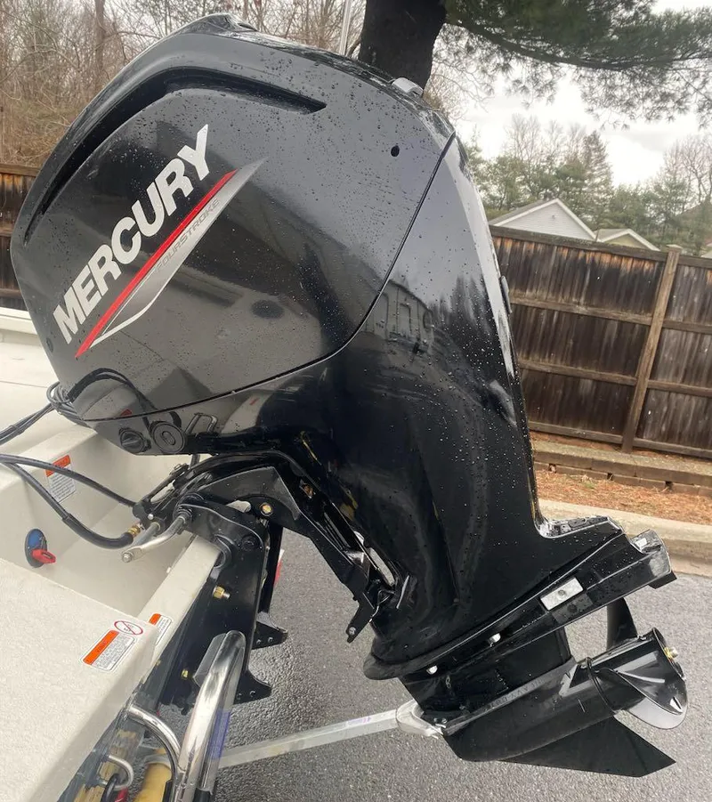 Slide: The Image of 2024 Ranger RB190 boat with Mercury outboard motor in a driveway. - 16