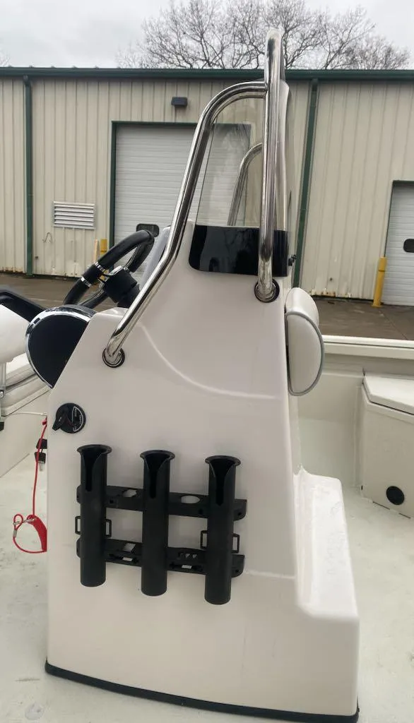 Slide: The Image of 2024 Ranger RB190 boat console with rod holders, parked near industrial building. - 4