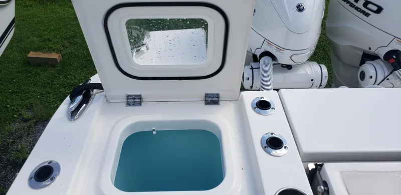 Slide: The Image of 2024 Pursuit S 358 Sport boat livewell and engine compartment. - 11