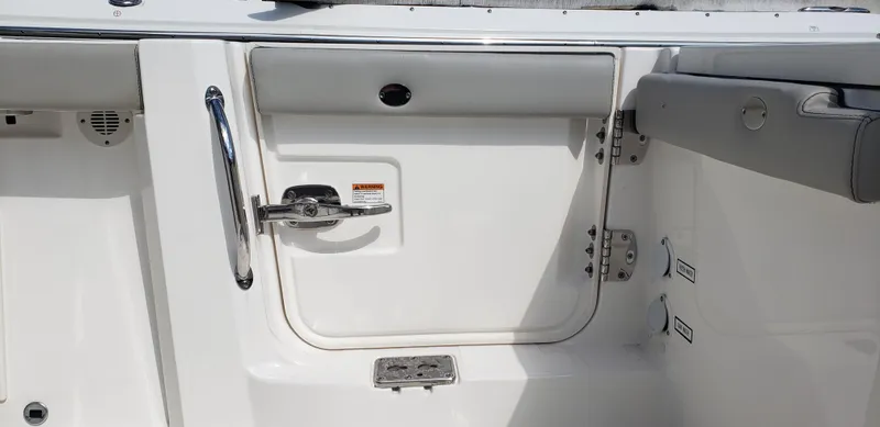 Slide: The Image of 2024 Pursuit S 358 Sport boat interior with stainless steel hardware and cushioned seating. - 14