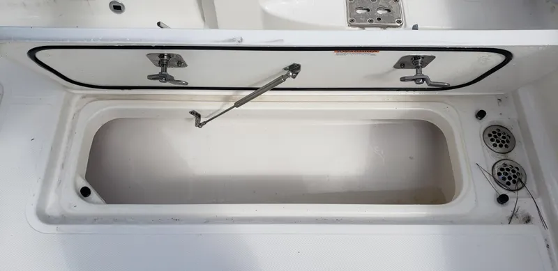 Slide: The Image of Open storage compartment on a 2024 Pursuit S 358 Sport boat. - 17