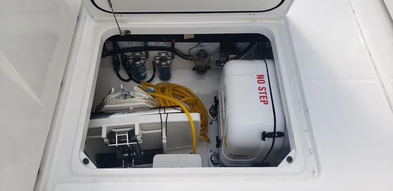 Slide: The Image of 2024 Pursuit S 358 Sport boat engine compartment with equipment and No Step label. - 18