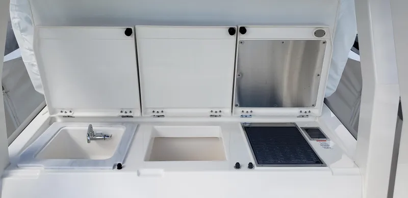 Slide: The Image of 2024 Pursuit S 358 Sport boat galley with sink, storage, and grill. - 20