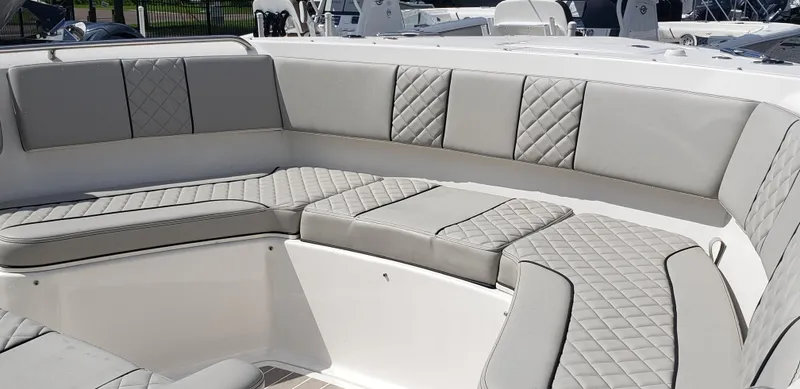 Slide: The Image of 2024 Pursuit S 358 Sport boat with luxurious, quilted seating in the bow area. - 24
