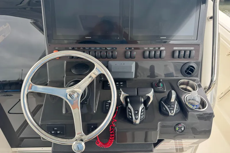 Slide: The Image of 2024 Pursuit S 358 Sport helm with dual Garmin displays and modern controls. - 26