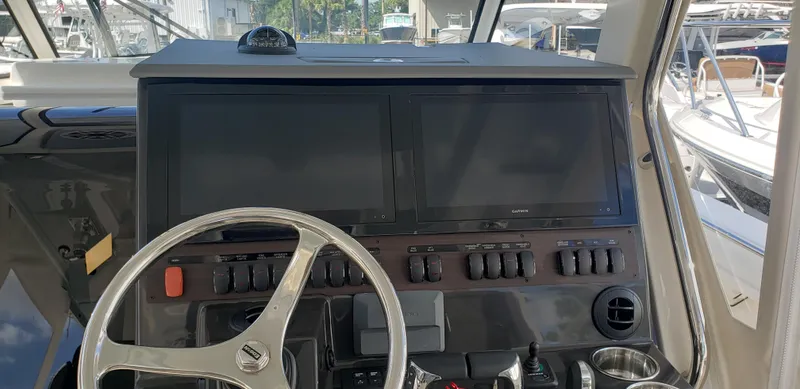 Slide: The Image of 2024 Pursuit S 358 Sport boat dashboard with dual screens and steering wheel. - 27