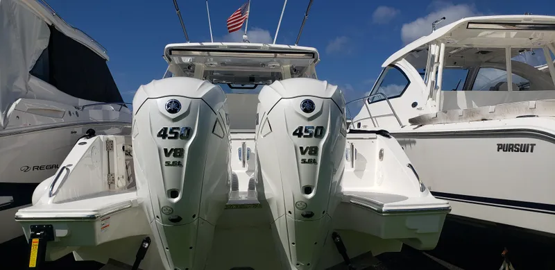 Slide: The Image of 2024 Pursuit S 358 Sport boat with twin 450 V8 engines docked. - 3