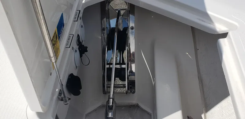 Slide: The Image of 2024 Pursuit S 358 Sport boat anchor compartment with stainless steel hardware. - 33
