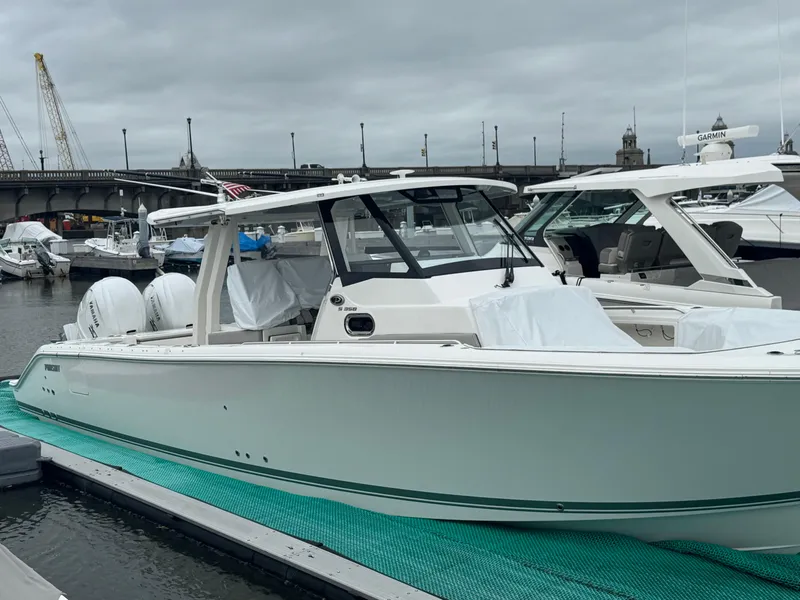 Slide: The Image of 2024 Pursuit S 358 Sport boat docked at marina under cloudy sky. - 4