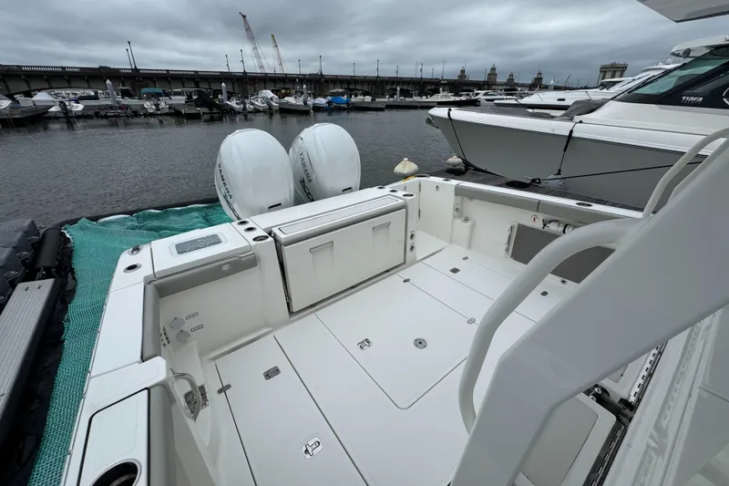 Slide: The Image of 2024 Pursuit S 358 Sport boat with dual engines docked at marina. - 8