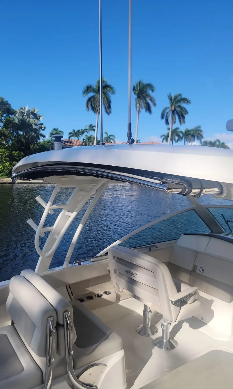Slide: The Image of Boston Whaler 320 Vantage 2021 on a sunny waterway. - 10