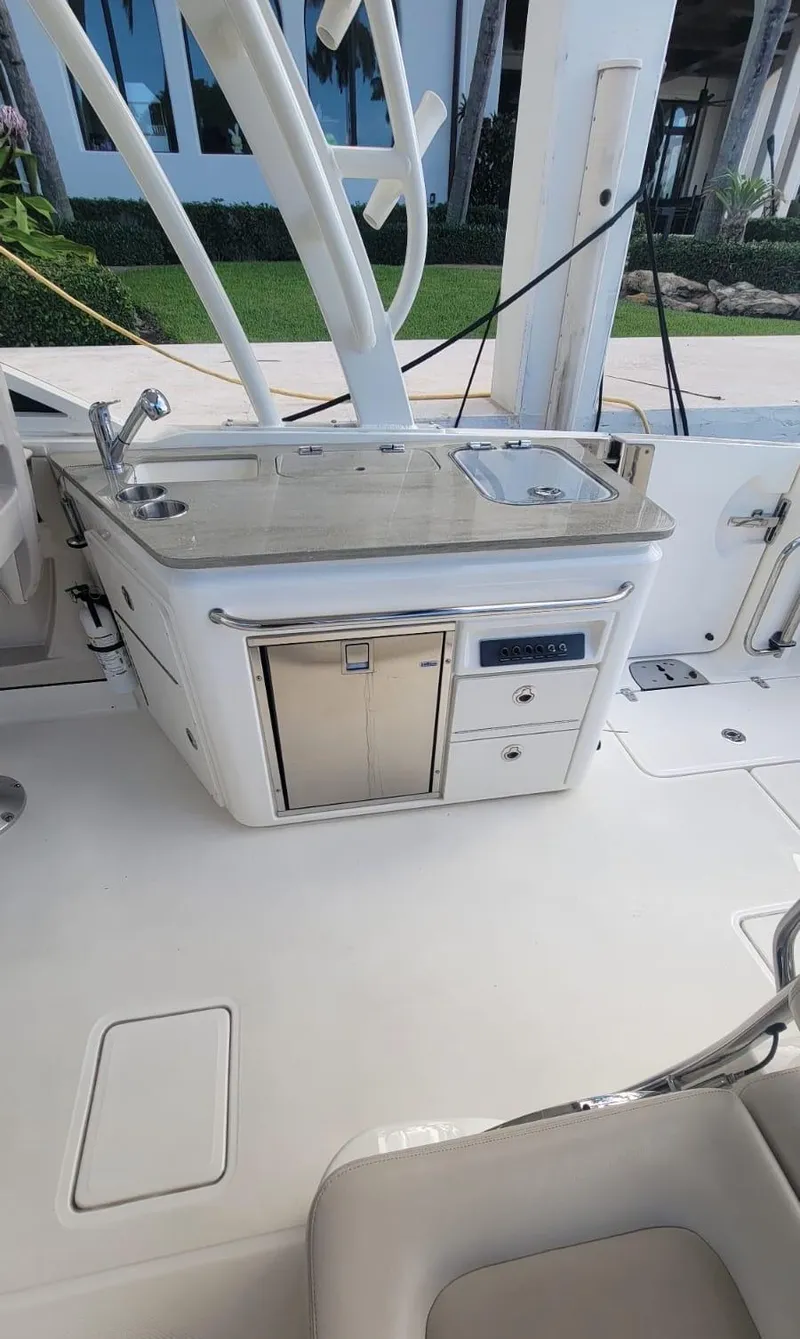 Slide: The Image of 2021 Boston Whaler 320 Vantage with onboard kitchenette and sink. - 14