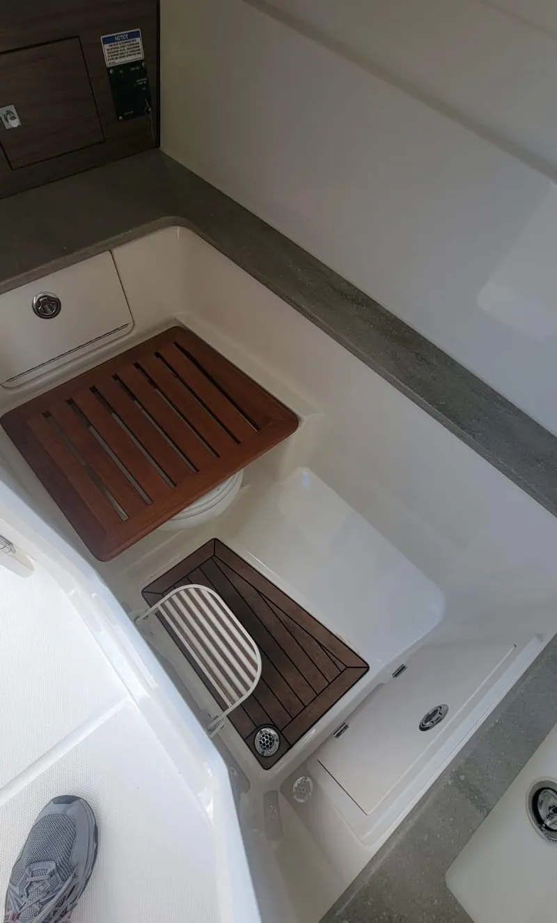 Slide: The Image of Interior of 2021 Boston Whaler 320 Vantage with wooden flooring. - 17