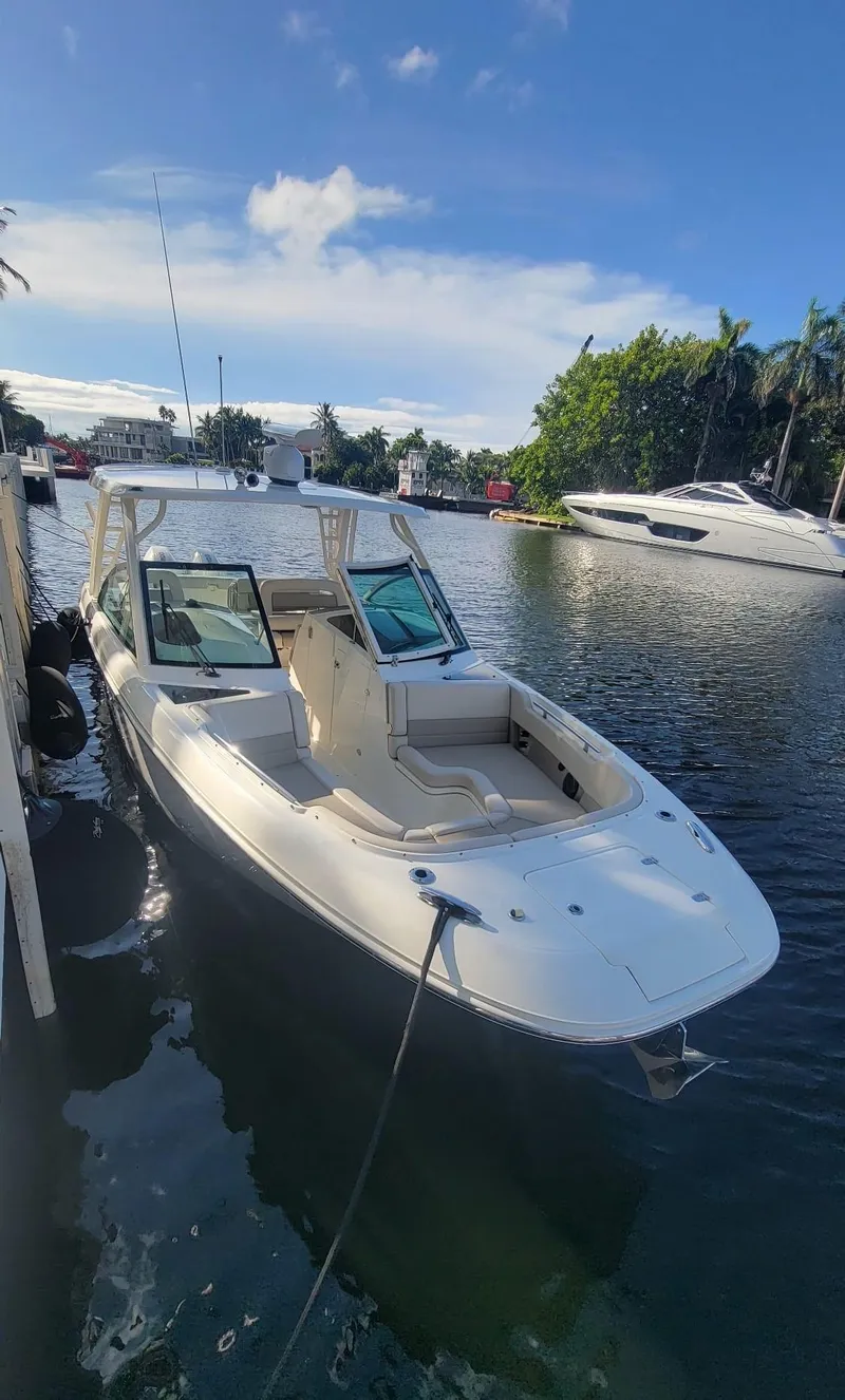 Slide: The Image of Boston Whaler 320 Vantage 2021 docked on a sunny day. - 2
