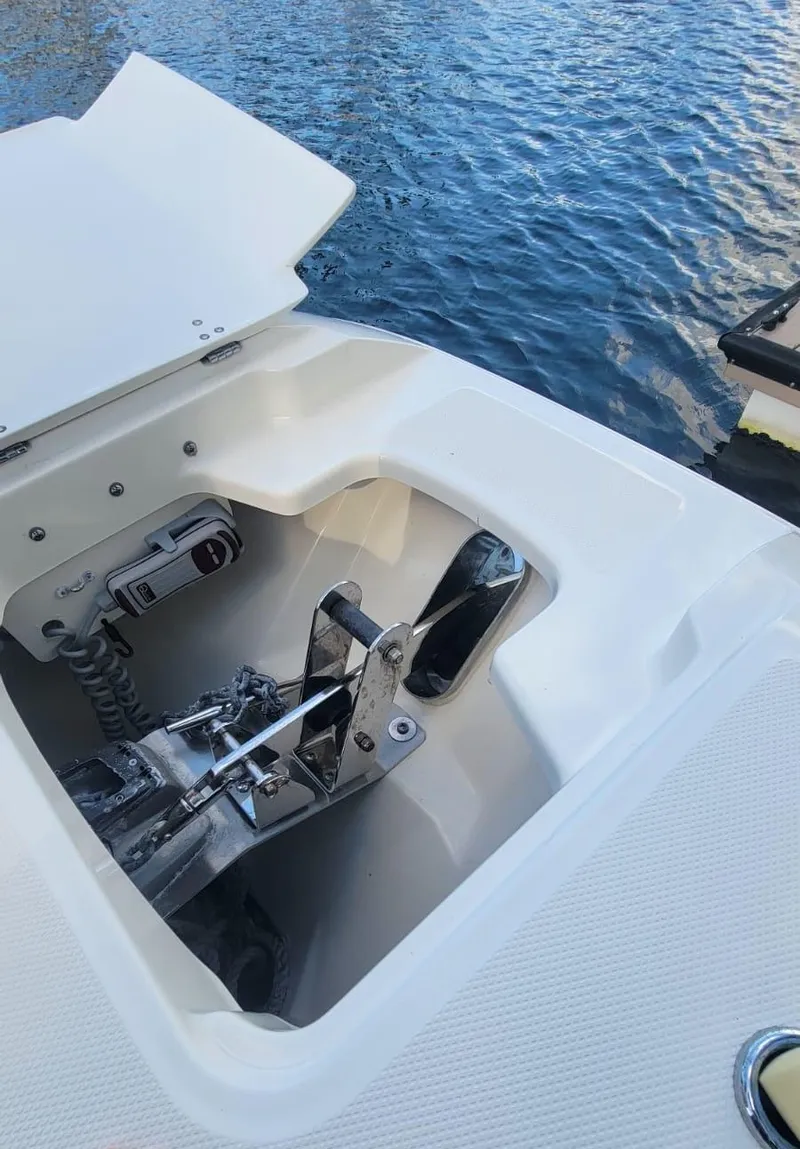 Slide: The Image of Anchor compartment of 2021 Boston Whaler 320 Vantage by the water. - 9