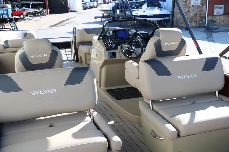 Slide: The Image of 2024 Sylvan L3 RLZ boat interior with beige seating and modern dashboard. - 17